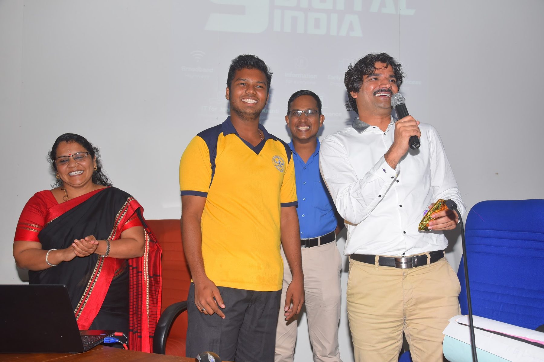 Students actively raising hands during a Q&A session at a higher education institute